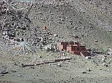 Tibet Kailash 08 Kora 24 Dirapuk Gompa Dirapuk Gompa (4890m) shines in a brief sunny period among the rain and hail. The Gompa takes its name from the words dira (meaning female-yak-horn) and puk (cave). The great monk Gtsangpa meditated her, supposedly from 1213 to 1217, and Buddhists say he first discovered the kora route around Kailash. He was led to Dirapuk by a yak that turned out to be the lion-faced-goddess Dakini (Khadroma), who guards the Khando Sanglam La. Just below the Gompa, another ashram is being built by Pujya Swami Chidanand Saraswatiji of the India Heritage Research Foundation.